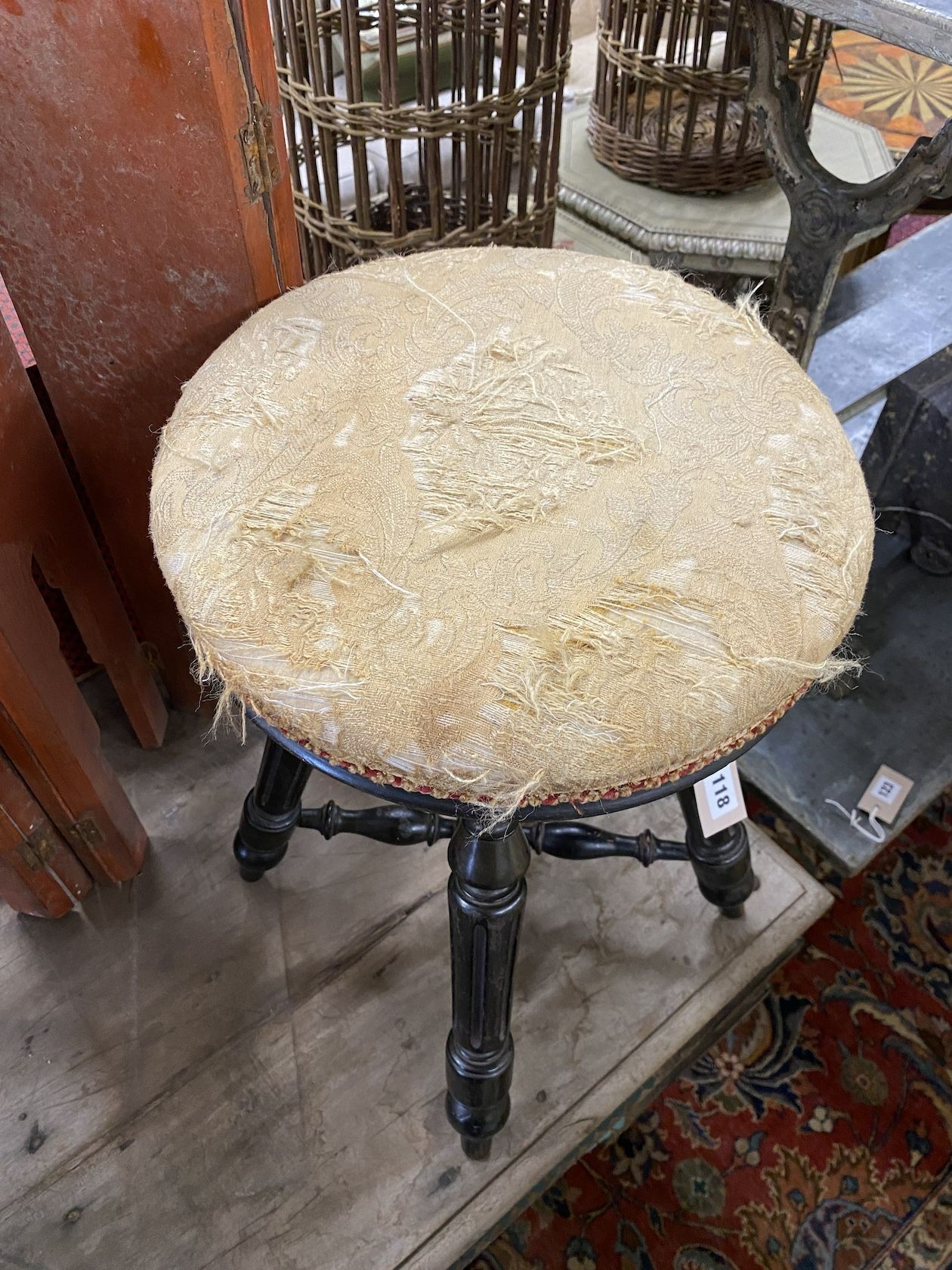A Victorian ebonised adjustable revolving piano stool